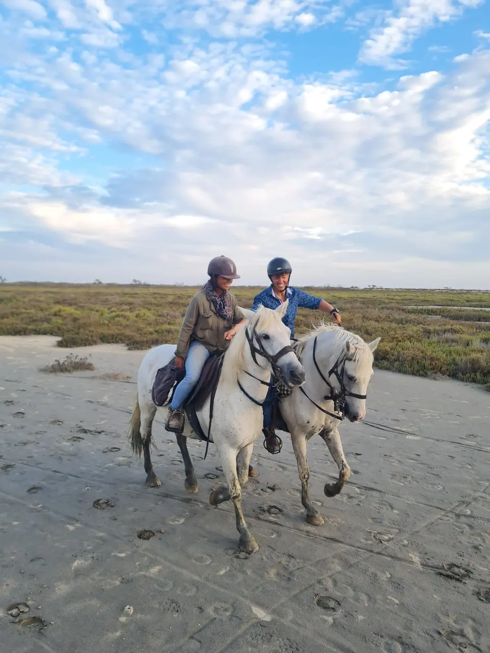 Deux cavaliers à cheval sur la plage en Camargue, lors d'une promenade avec La Fadaise, Saintes-Maries-de-la-Mer.